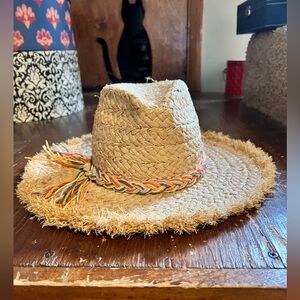Hat Attack fringed raffia straw hat with pastel colored braid at brim.
